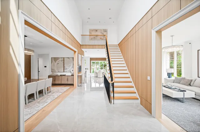 a view of a livingroom with furniture and stairs