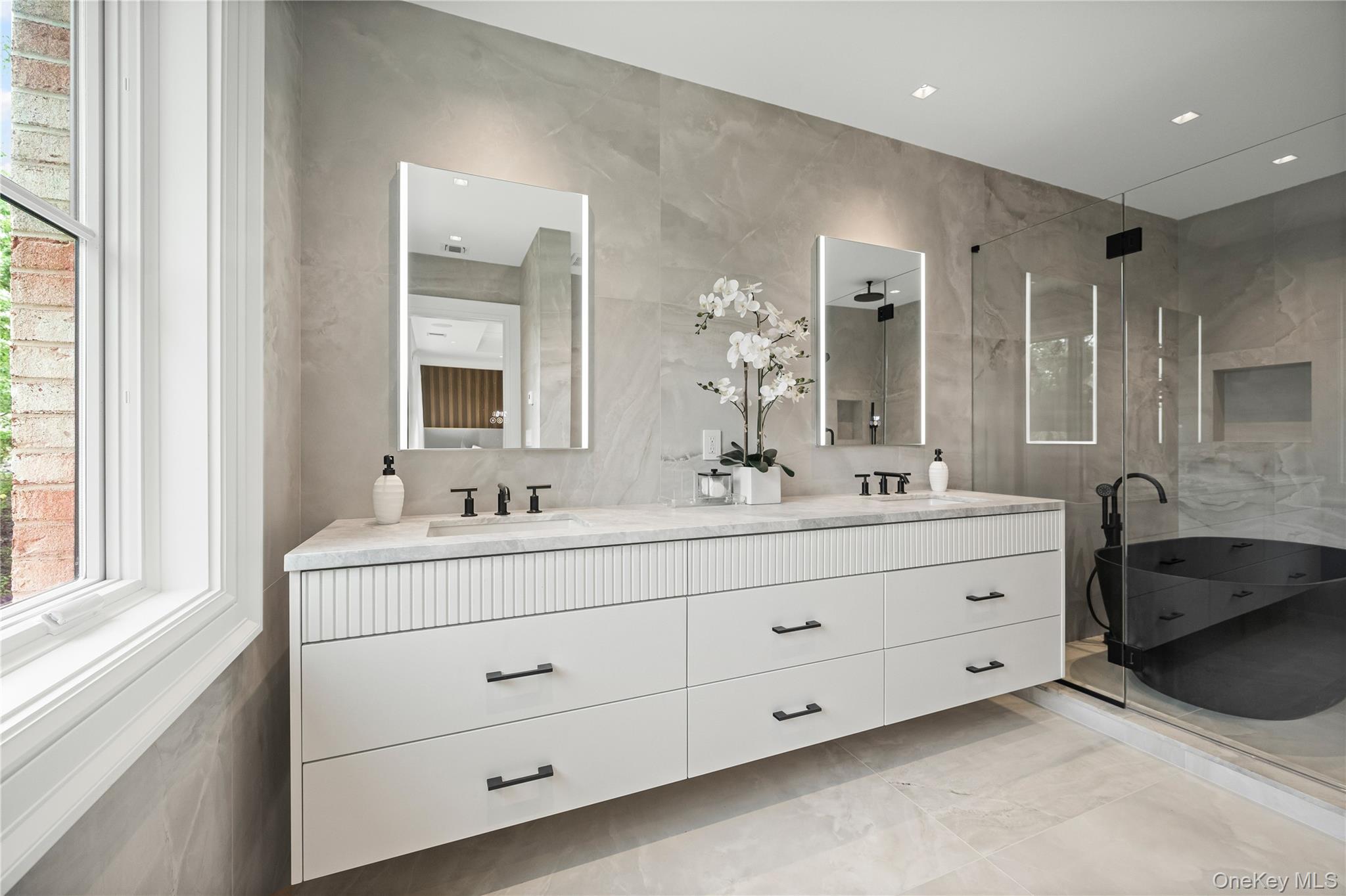 7 Mirrielees Road Great Neck, NY 11021 - Photo 36 of 47 a bathroom with double sink and a mirror