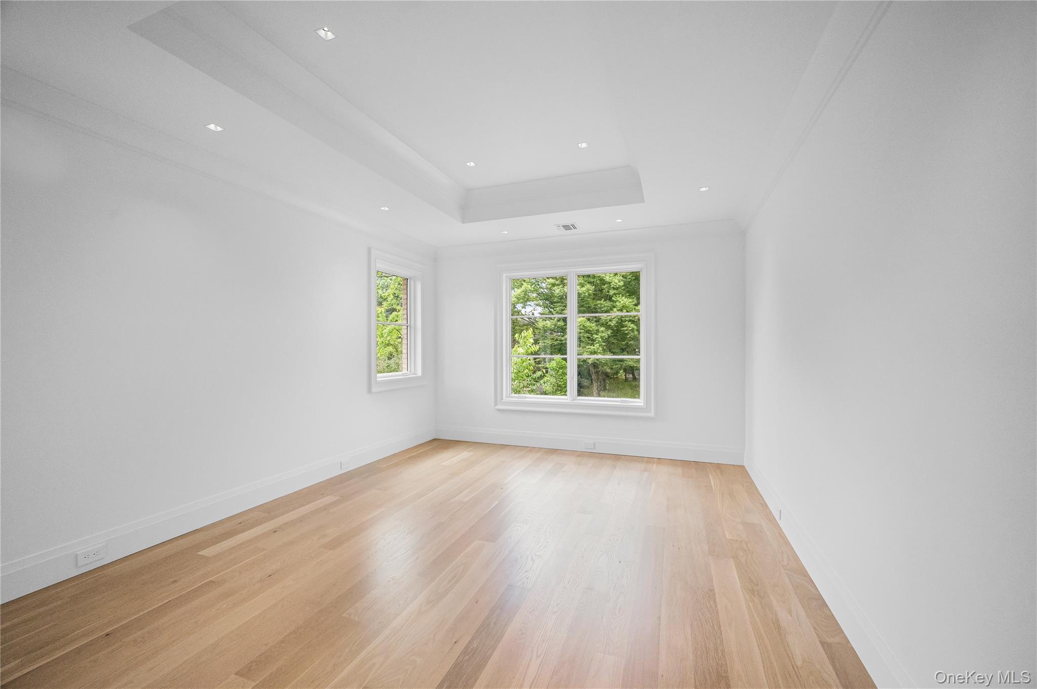 7 Mirrielees Road Great Neck, NY 11021 - Photo 39 of 47 an empty room with wooden floor and windows