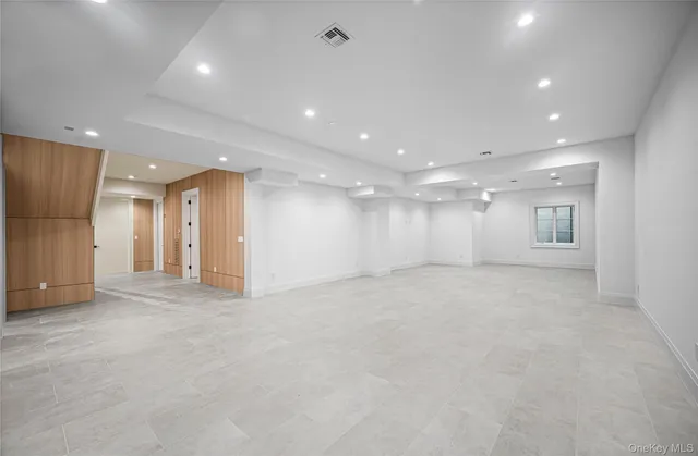 an empty room with windows and pillars in it