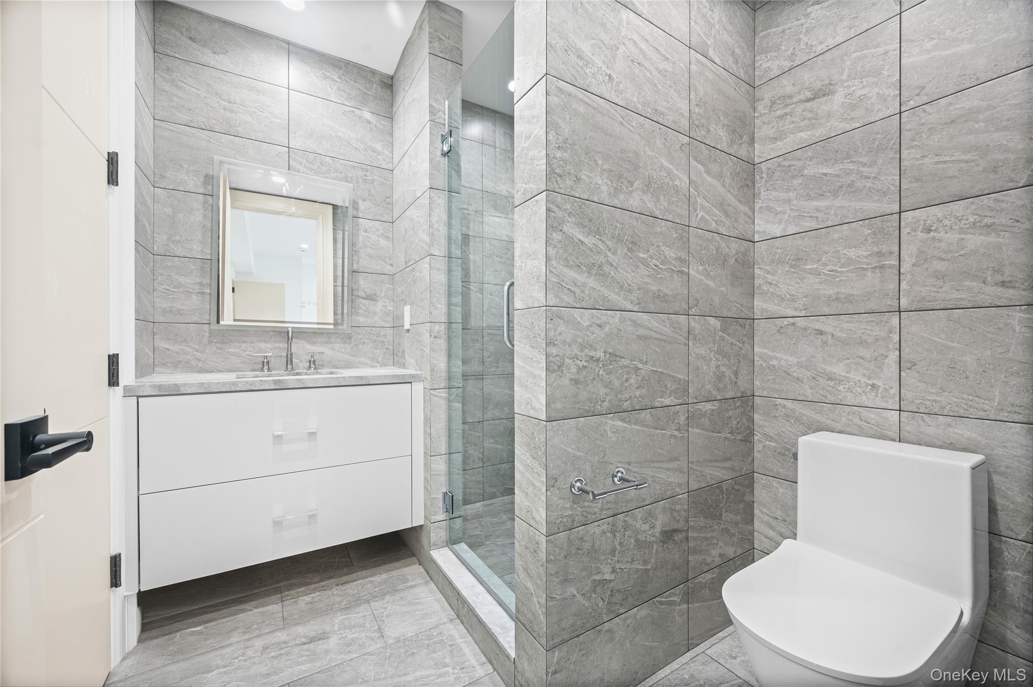 7 Mirrielees Road Great Neck, NY 11021 - Photo 45 of 47 a bathroom with a toilet sink and shower