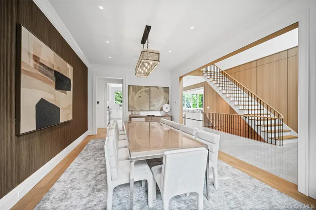 a dining room with wooden floor and a hallway