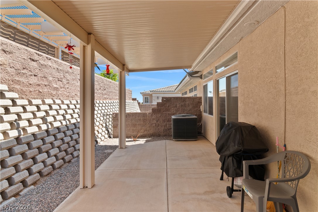 3376 Partridge Run Street Laughlin, NV 89029 - Photo 59 of 92 A spacious covered patio provides a shaded outdoor living area with privacy retaining walls.