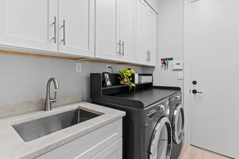 a kitchen with stainless steel appliances granite countertop a sink a stove and cabinets