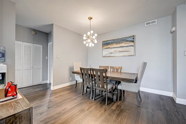 a view of a dining room with furniture and wooden floor
