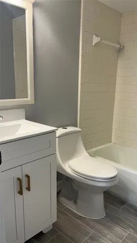a bathroom with a toilet and a bathtub