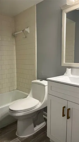 an empty room with wooden floor and entrance