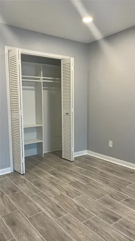 a view of an empty room with a closet