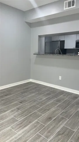 a kitchen with granite countertop a sink and cabinets