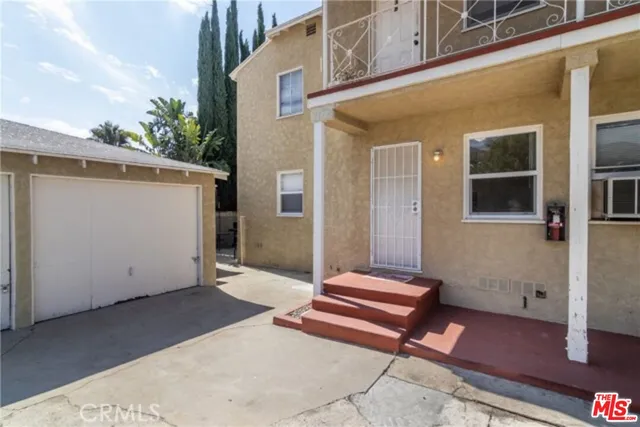 a backyard of a house with wooden floor and fence