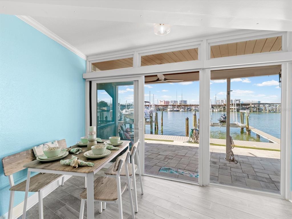 205 Dolphin Point, Unit 4 Clearwater Beach, FL 33767 - Photo 16 of 23 a view of a dining room with furniture window and outside view