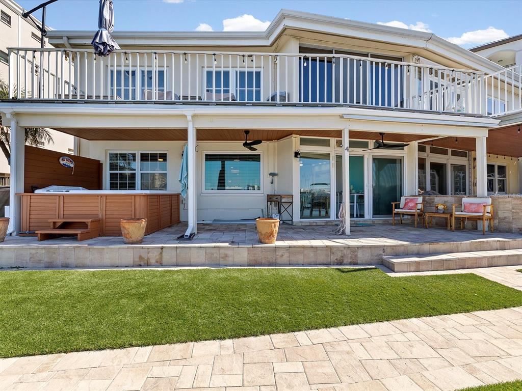 205 Dolphin Point, Unit 4 Clearwater Beach, FL 33767 - Photo 3 of 23 a view of a house with a yard balcony and sitting area