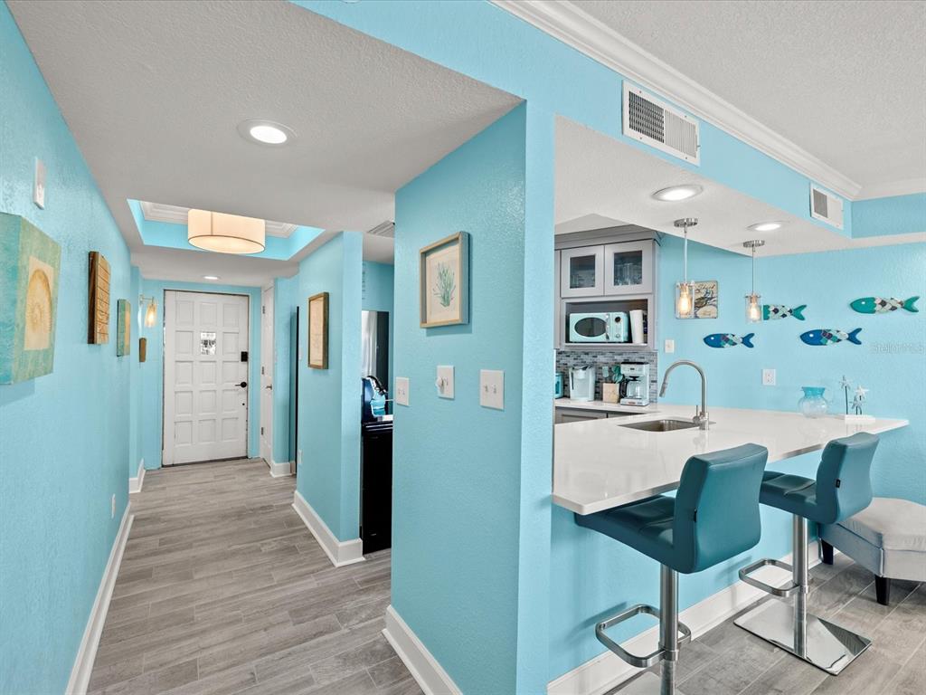 205 Dolphin Point, Unit 4 Clearwater Beach, FL 33767 - Photo 6 of 23 a view of a dining room with furniture