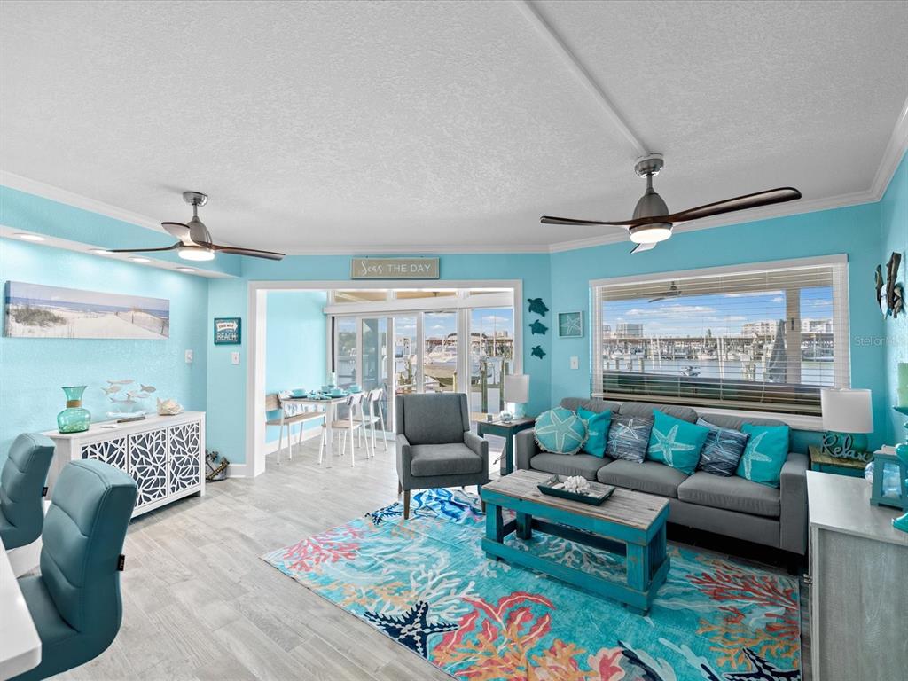 205 Dolphin Point, Unit 4 Clearwater Beach, FL 33767 - Photo 8 of 23 a living room with furniture and a large window