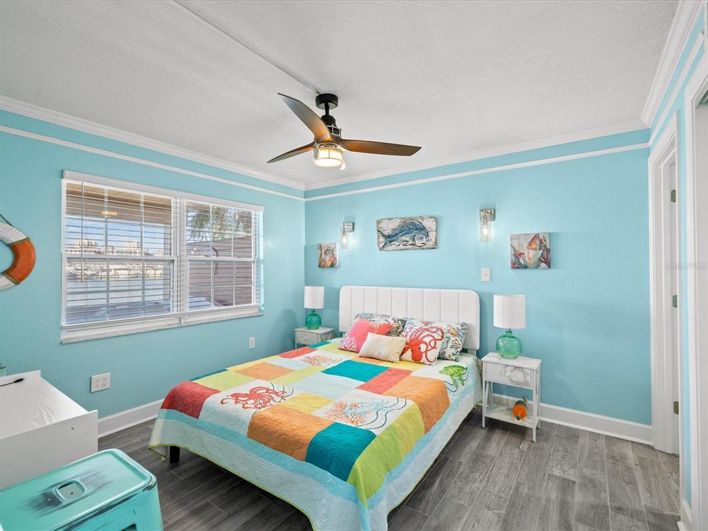 205 Dolphin Point, Unit 4 Clearwater Beach, FL 33767 - Photo 10 of 23 a bedroom with a bed and a window
