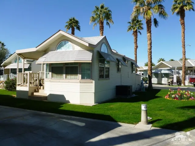 a front view of a house with a garden and yard