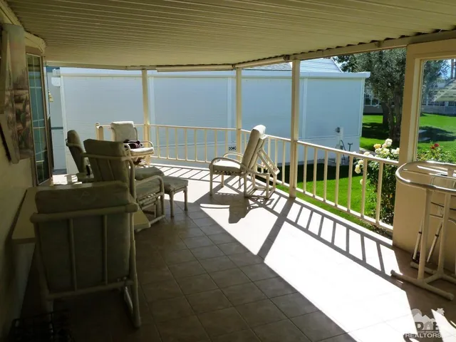 a view of a balcony with chairs