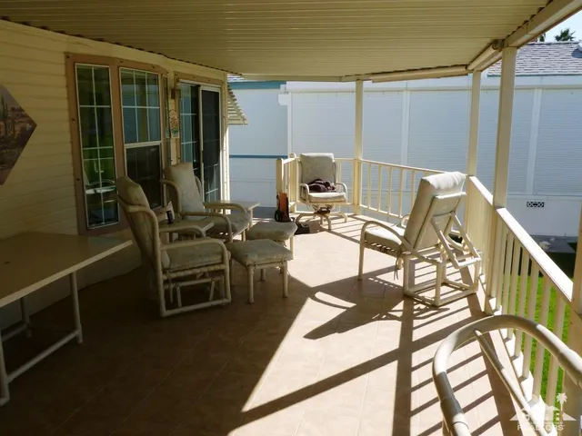 a balcony with table and chairs
