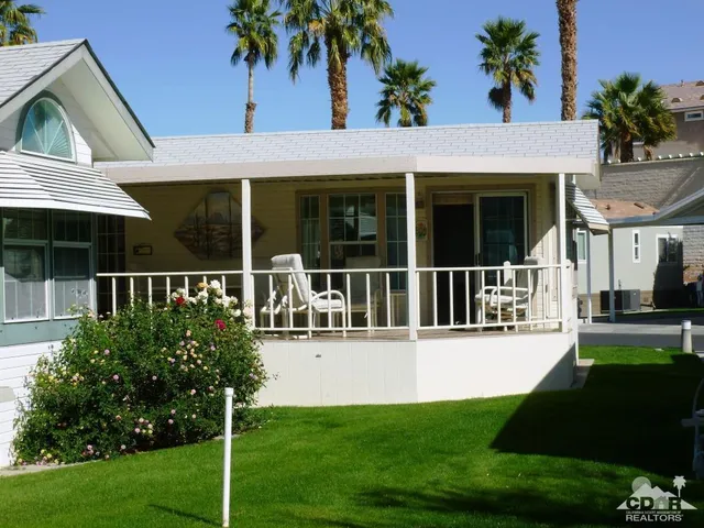 a view of a house with a garden and plants