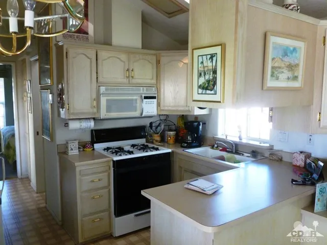 a kitchen with a stove a refrigerator and a sink