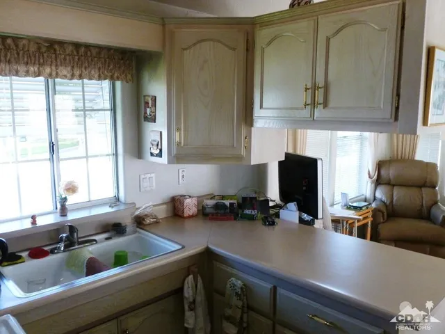 a kitchen with furniture a sink and a window