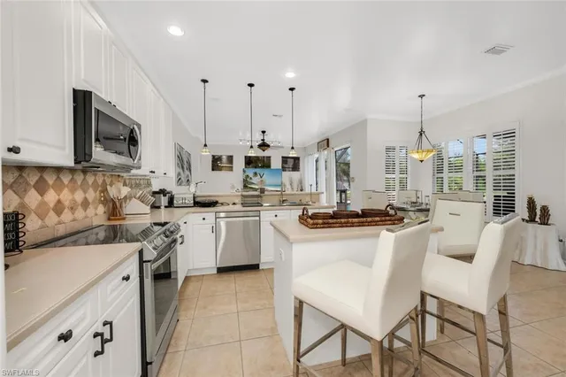 a kitchen with appliances a sink and cabinets