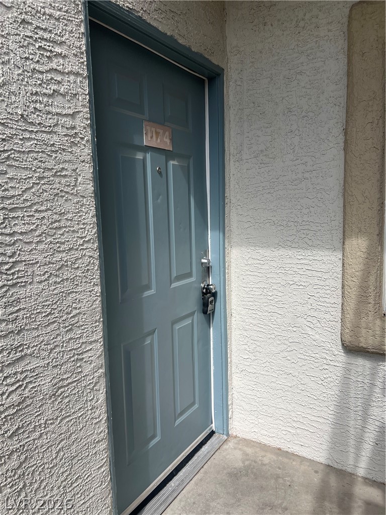 3318 North Decatur Boulevard, Unit 1174 Las Vegas, NV 89130 - Photo 2 of 23 An inviting entrance awaits behind this sturdy paneled door, offering both privacy and appeal.