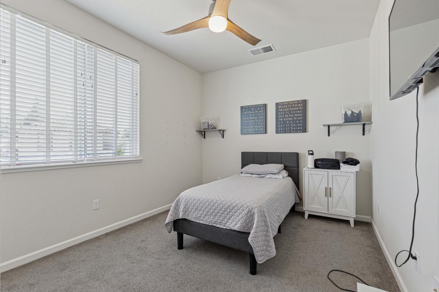 3264 Showcase Way Modesto, CA 95356 - Photo 21 of 31 a bedroom with a bed and a window