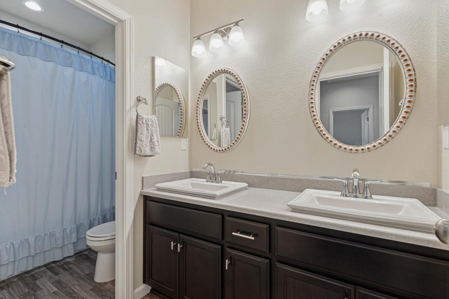 3264 Showcase Way Modesto, CA 95356 - Photo 22 of 31 a bathroom with a double vanity sink and a mirror