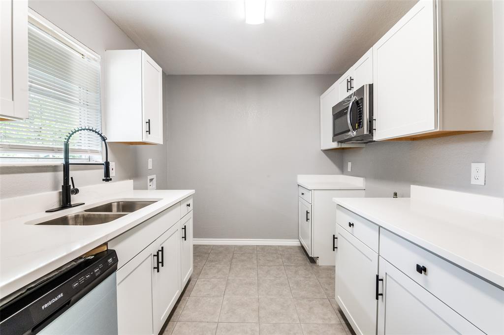 728 Oceanview Drive Dallas, TX 75232 - Photo 11 of 24 a kitchen with a sink stove and cabinets
