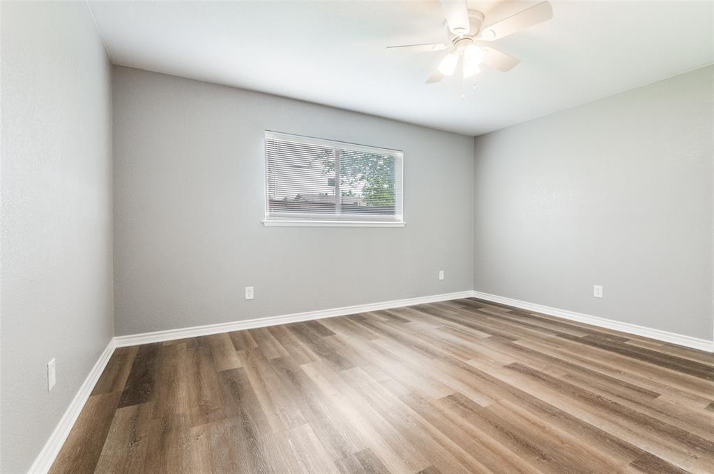 728 Oceanview Drive Dallas, TX 75232 - Photo 16 of 24 an empty room with a window and a fan