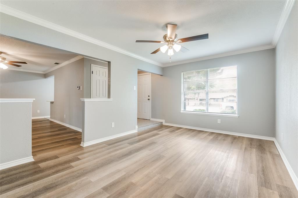 728 Oceanview Drive Dallas, TX 75232 - Photo 3 of 24 an empty room with wooden floor fan and windows