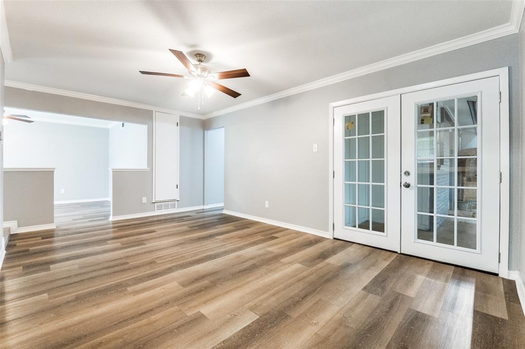 728 Oceanview Drive Dallas, TX 75232 - Photo 5 of 24 a view of empty room with wooden floor and fan