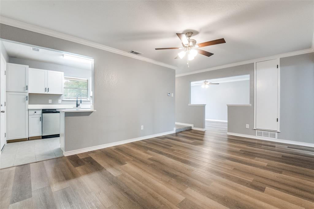 728 Oceanview Drive Dallas, TX 75232 - Photo 8 of 24 a view of an empty room with window and wooden floor