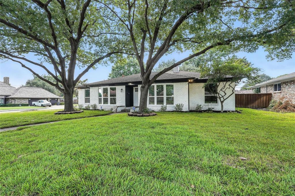 Mid-century home featuring brick siding