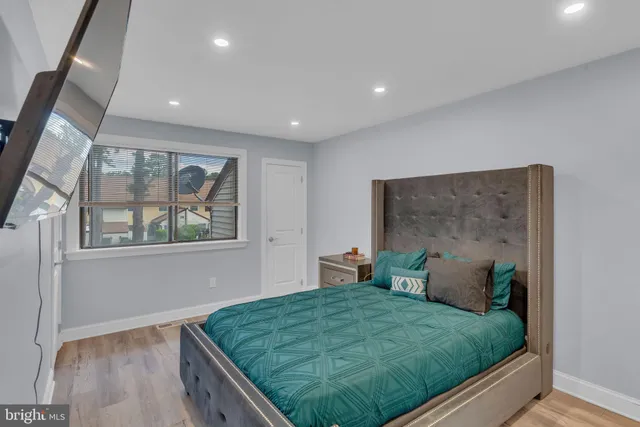 a bed sitting in a bedroom next to a window