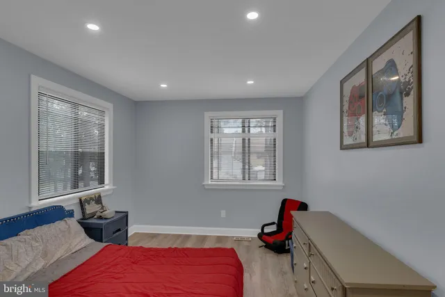 a bedroom with two beds and a window