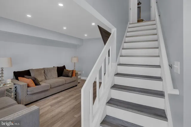 a living room with furniture and stairs