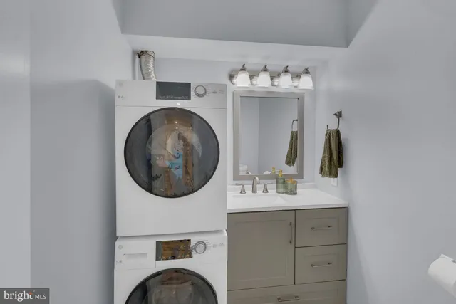 a bathroom with a sink vanity mirror and tub