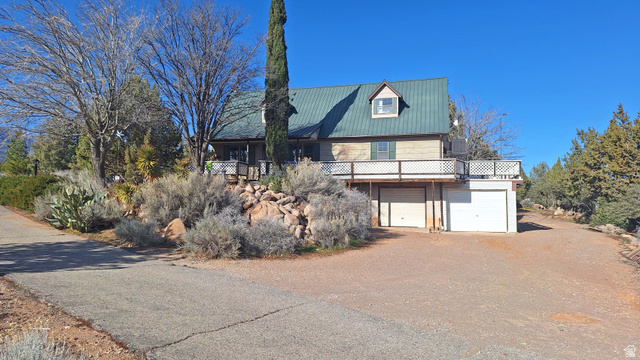 2000 Anderson Jct Road Toquerville, UT 84774 - Photo 27 of 45 View of front of property with driveway, a garage, a metal roof, and a wooden deck
