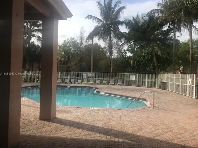 a view of a swimming pool with a yard