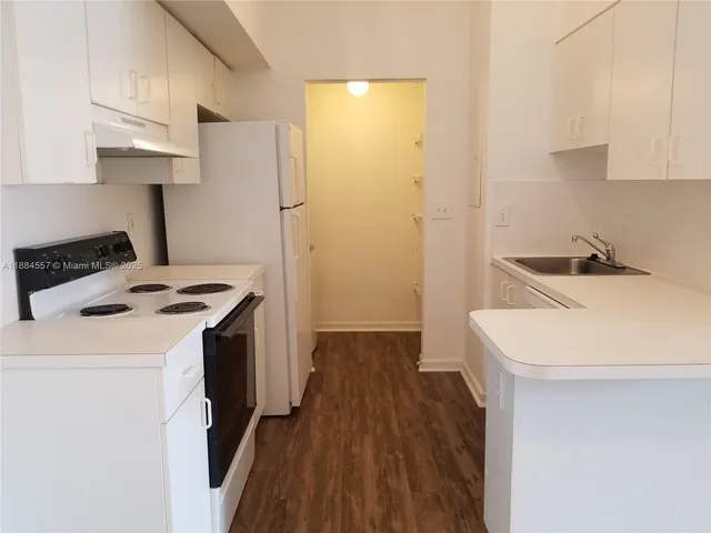 a kitchen with a sink a stove and refrigerator