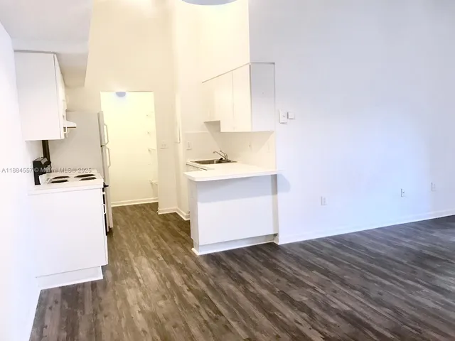 a kitchen with a sink a stove and a refrigerator