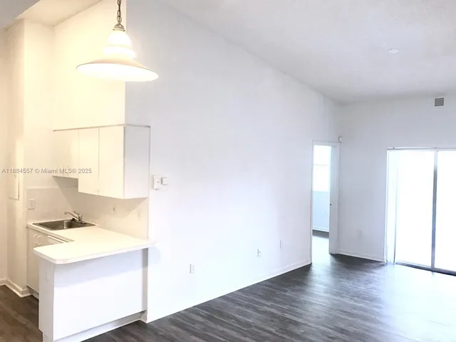 a view of storage and utility room with wooden floor