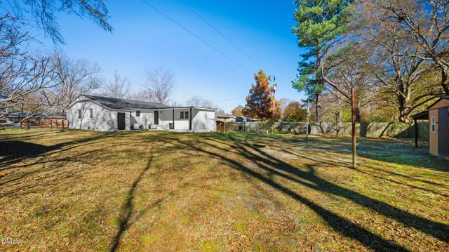 a view of residential houses with yard and swimming pool