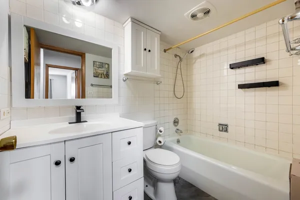 a bathroom with a bath tub with a shower
