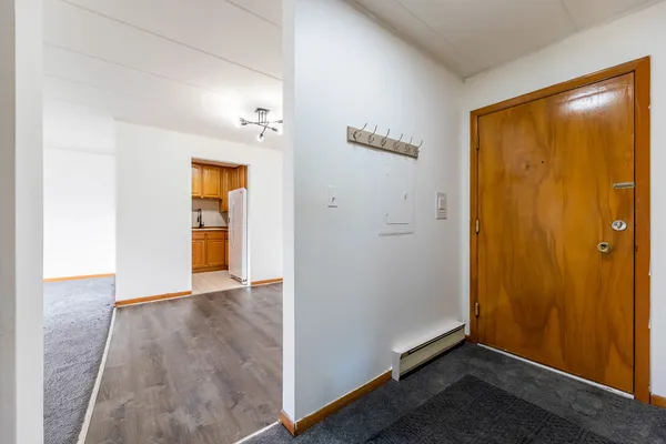 an empty room with closet and wooden floor