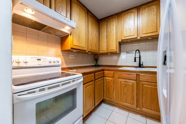 a kitchen with granite countertop cabinets stainless steel appliances and a sink