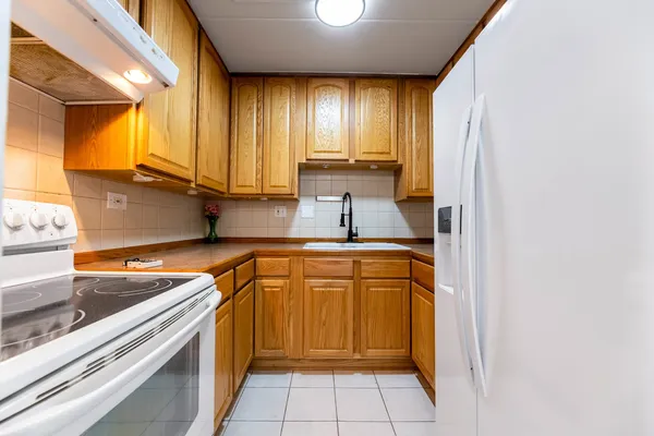 a kitchen with stainless steel appliances granite countertop a sink and a stove