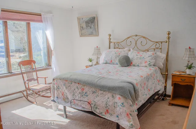 a bedroom with a bed a table and chair